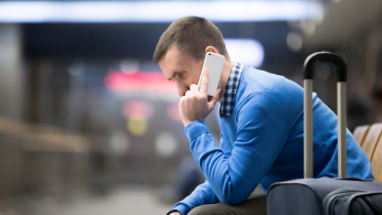 Young Man On Phone At Airport